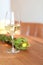 Glass of white wine at the restaurant wooden table. Horizontal image- sunlights at the restaurant interiors, nobody. bar counter