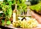 Glass of White wine ripe grapes and bread on table in vineyard