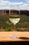 A glass of white wine on a terrace with mountains in the background. Australian wine concept.