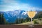 Glass of white wine with view of mountains in Ukraine. Beautiful view of rocks, forest and blue sky in Carpathian Mountains.