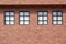 Glass windows on brick wall of 2 house story in vintage style