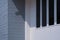 Glass windows on white cement and gray artificial wooden wall outside of house building