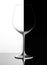 Glass of wine on a black and white background, with reflection. Domino concept