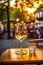 glass of wine and cheese plate on a cafe table evening street