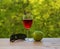 Glass of wine green apple and sunglasses on table