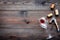 Glass with wine sediment, corkscrew and corks on dark wooden background top view copyspace