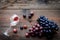 Glass with wine sediment and grape on dark wooden background top view copyspace