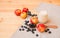 Glass of yogurt, apples, bilberries and  oat flakes in bowl on wooden table