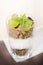 Glass of yogurt with cereals, fruit and mint