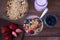 Glass with yogurt, cereals, strawberries and blueberries on wooden table - top