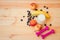 Glass of yogurt,  dumbbells, apples, banana and blueberries on wooden background. Healthy lifestyle concept. Selective focus