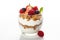 A glass of yogurt topped with berries and granola