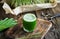 A glass of young barley grass juice with fresh barley grass