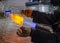 glassblower blows glass balls from glass tubes burner with high temperature propane flame close-up glassblower hand
