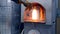 Glassblower. manufacturer of glass products. man heats glass in a furnace