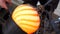 Glassblowing crafter rounds the hot-striped vase  with wet wood tool at the end of the glass blowing pipe. Traditional glass art