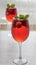 Glasse with a refreshing drink with strawberries and mint on a table.