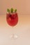 Glasse with a refreshing drink with strawberries and mint on a table.