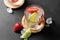 A glasse with summer strawberry soda drink or mojito with strawberry, ice cubes and lime on light background