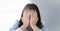 Glasses Asian Thai - Chinese woman is shying and crying face behind her hand. Shied concept