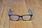 Glasses black and blue Frame contemporary style on wood background