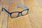 Glasses black and blue Frame contemporary style on wood background