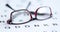 Glasses in black red frames lying on eye examination table 4k movie