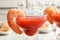 Glasses with boiled shrimps and tomato sauce