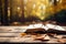 Glasses on a book on the table against the backdrop of natural bokeh. Educational concepts and knowledge. Autumn