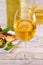 Glasses and bottle of white wine. Grilled dorado fish with vegetables