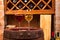 Glasses and bottles of red and white wine on old barrel in wine cellar