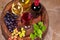 Glasses and bottles of red and white wine on old barrel in wine cellar