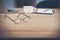 Glasses of Business workspace on wooden table.