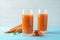 Glasses with carrot juice and fresh vegetable