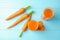 Glasses with carrot juice and fresh vegetable on wooden table, top view