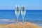 Glasses of champagne on the beach sand