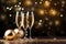 Glasses, champagne gold, streamers, baubles, confetti and bokeh effect in the background.New Year\\\'s Eve