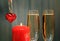 Glasses with champagne with heart and candle