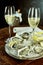 Glasses of champagne and oysters on table