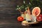 Glasses of cocktail with citrus on wooden background