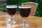 Glasses with cold dark strong Belgian beer served outdoor