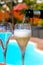 Glasses of cold white wine on roof terrace served outdoor in Corralejo, Fuerteventura in sunny day, pool with blue water