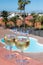 Glasses of cold white wine on roof terrace served outdoor in Corralejo, Fuerteventura in sunny day, pool with blue water