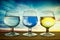 Glasses containing different skies. Brandy sniffer glassware with a different sunset in each one