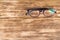 Glasses for correcting vision lie on a dark wooden background