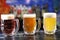 Glasses with different sorts of craft beer. Red, bronze and white beer in beer glasses on the bar.