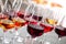 Glasses with different wines on blurred background