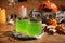 Glasses with drink prepared for Halloween party on wooden table