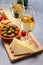 Glasses of dry fino sherry wine served with spanish tapas, manchego cheese, green olives, cheese crackers