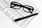 Glasses, financial documents and pencil